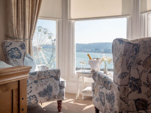 Elm Tree Hotel sea-view sitting room with wing-back chairs overlooking the bay