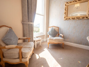 Two chairs alongside a bedroom window
