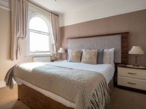 Elm Tree Hotel double bedroom with warm traditional decor and large sash windows
