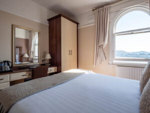 Elm Tree Hotel double bedroom with patterned headboard and traditional styling