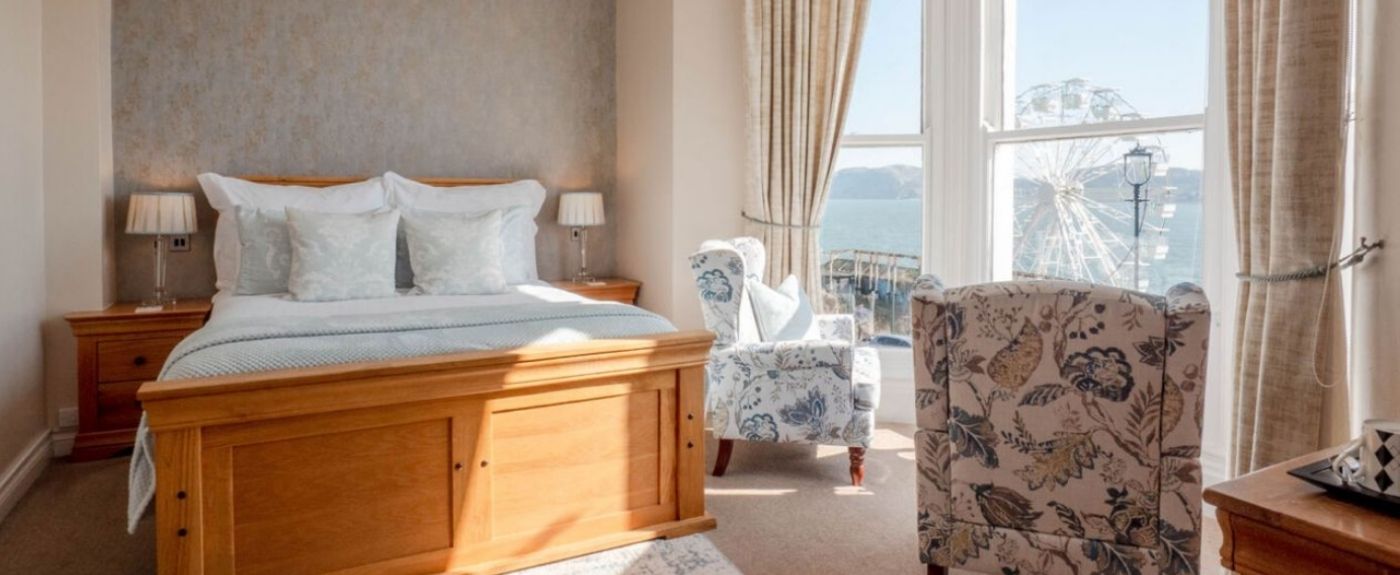 Bright, airy hotel bedroom interior with white curtains and natural daylight